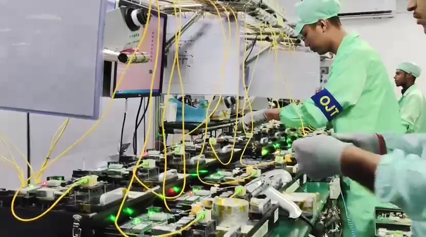 Technicians working with electronics test fixtures in a production environment