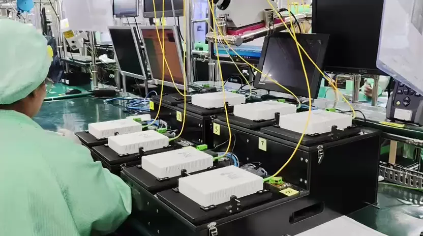 Operator monitoring a bank of electronics production test fixtures